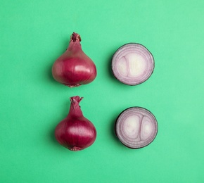 Beautiful composition with ripe red onions on color background