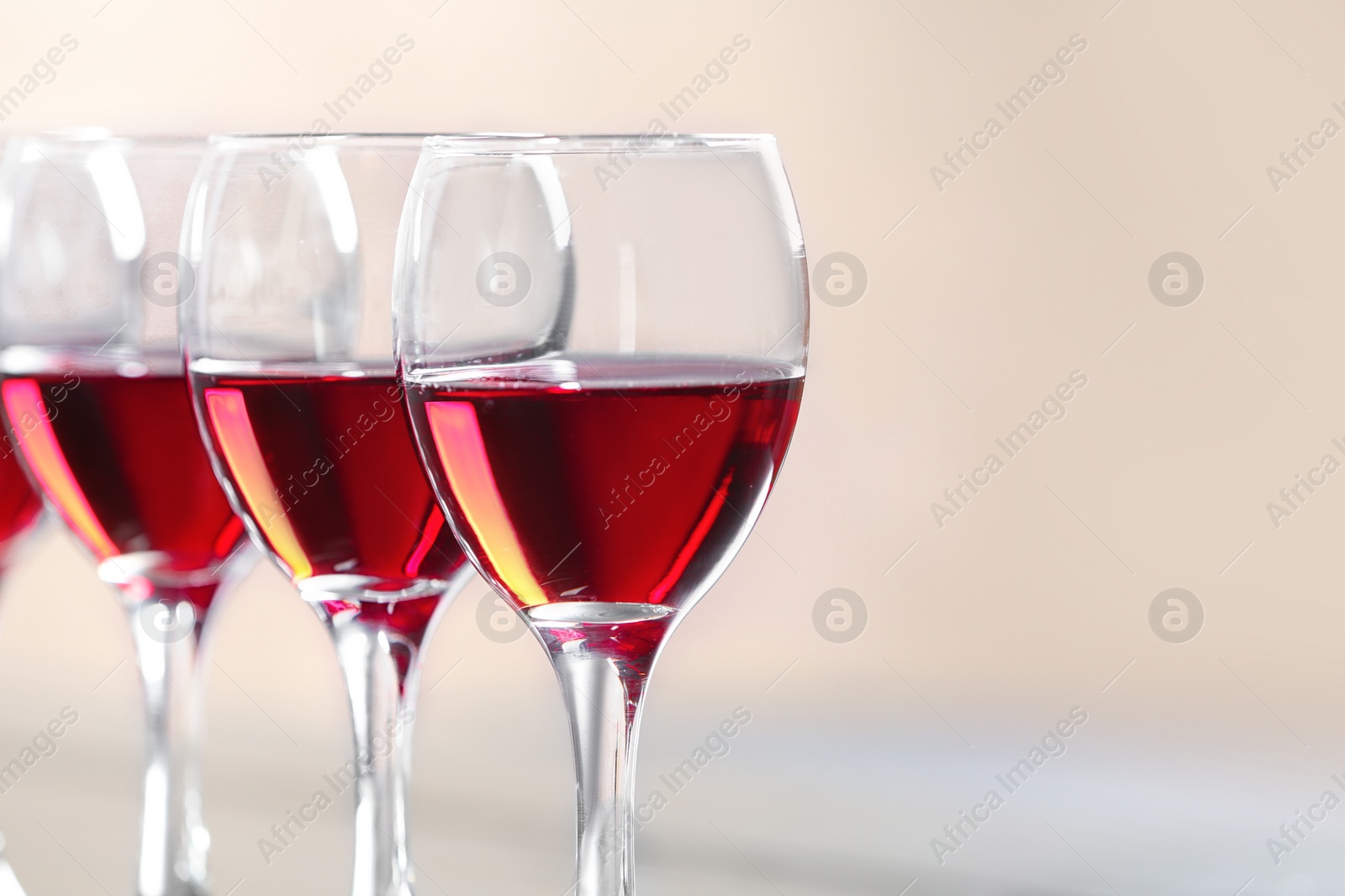 Photo of Glasses with delicious red wine, closeup