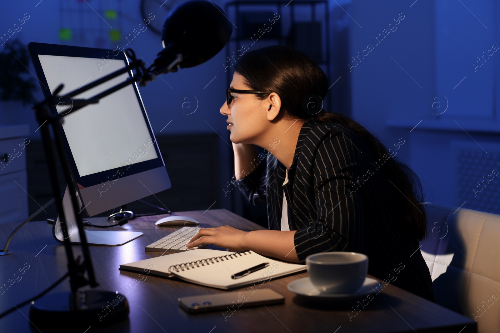 Photo of Tired businesswoman working at night in office