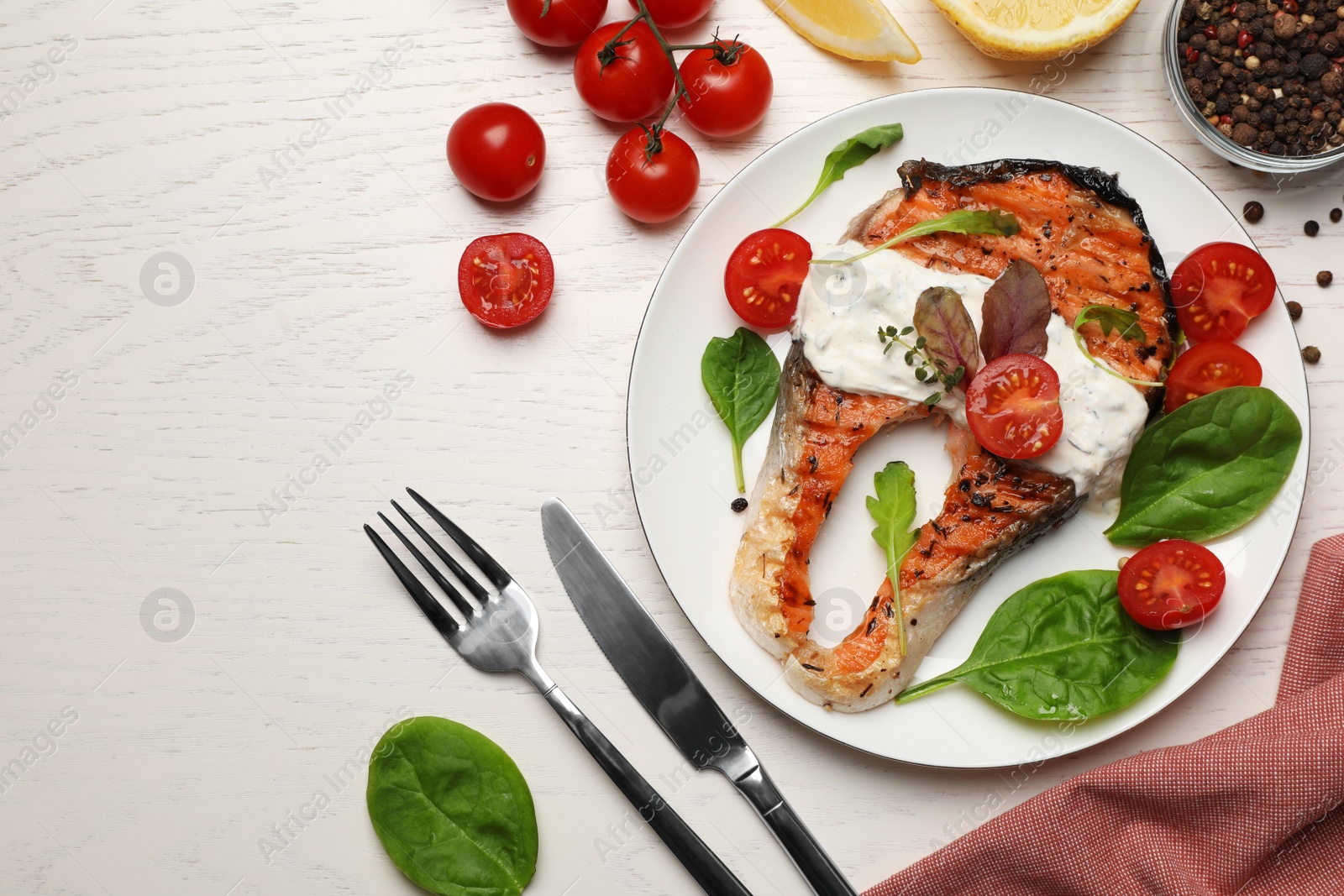 Photo of Tasty salmon steak served on white wooden table, flat lay. Space for text