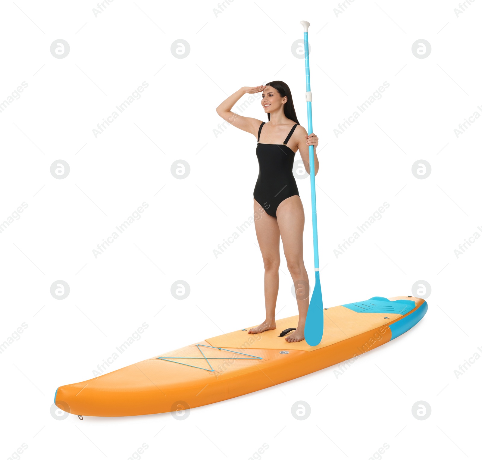 Photo of Happy woman with paddle on orange SUP board against white background