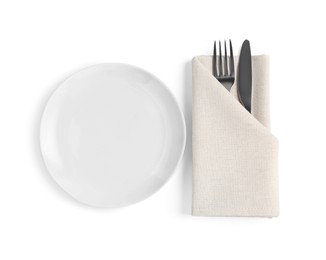 Empty plate, fork and knife wrapped in napkin on white background, top view