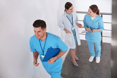 Team of professional doctors on staircase in clinic