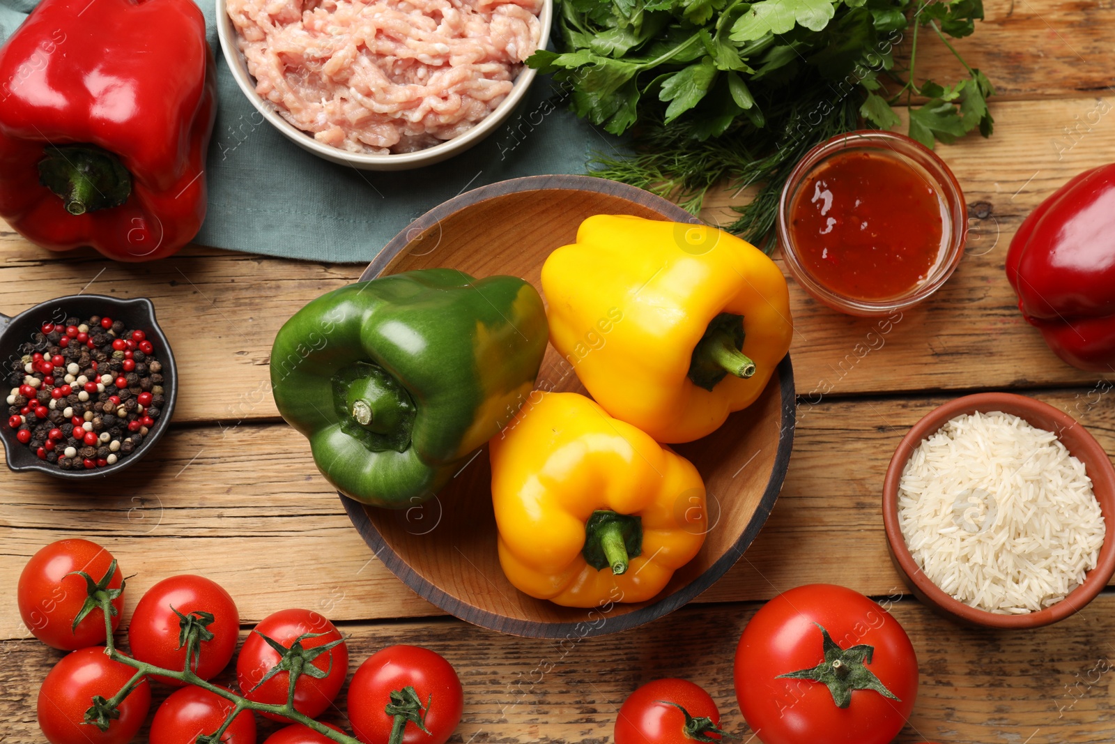 Photo of Making stuffed peppers. Vegetables and ground meat on wooden table, flat lay