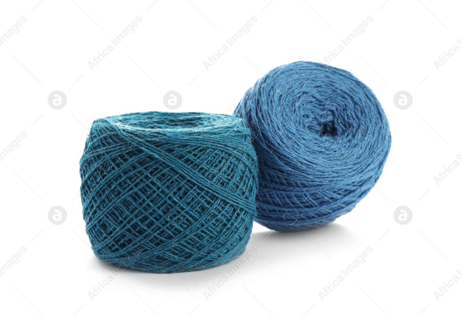 Photo of Clews of colorful knitting threads on white background