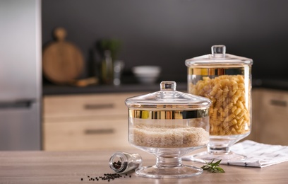 Photo of Raw foodstuff on wooden table in modern kitchen