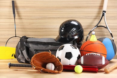 Photo of Many different sports equipment on wooden table