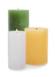 Photo of Set of burning wax candles on white background