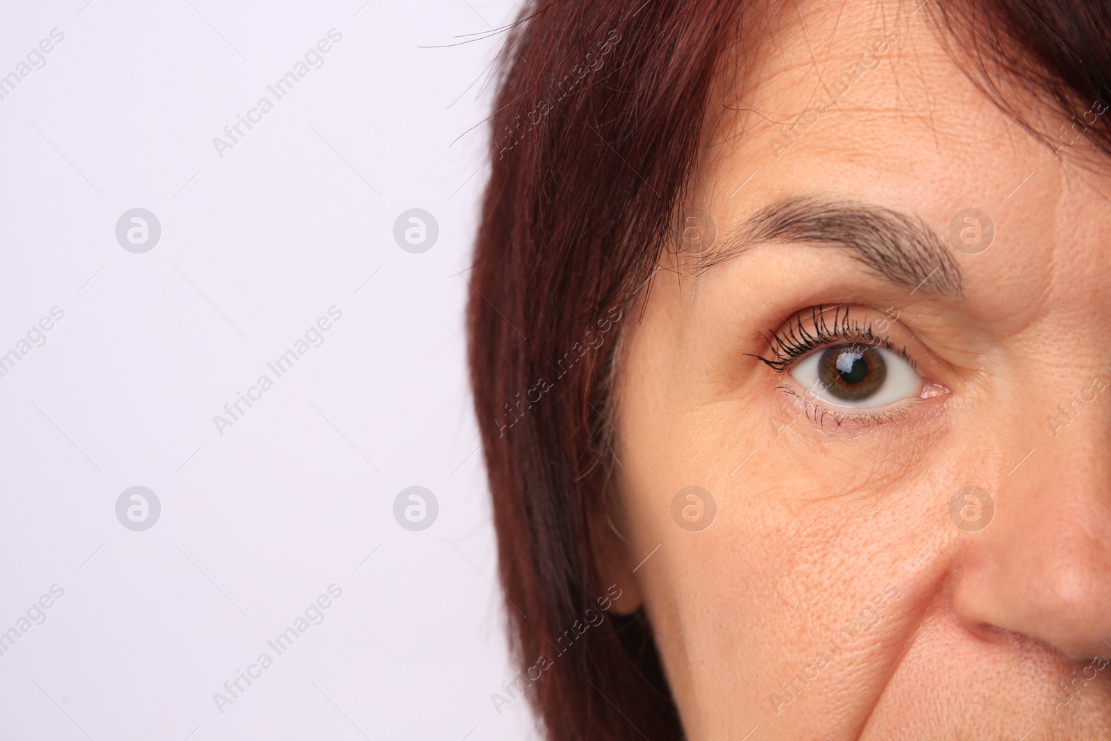 Photo of Skin care. Senior woman on white background, closeup. Space for text