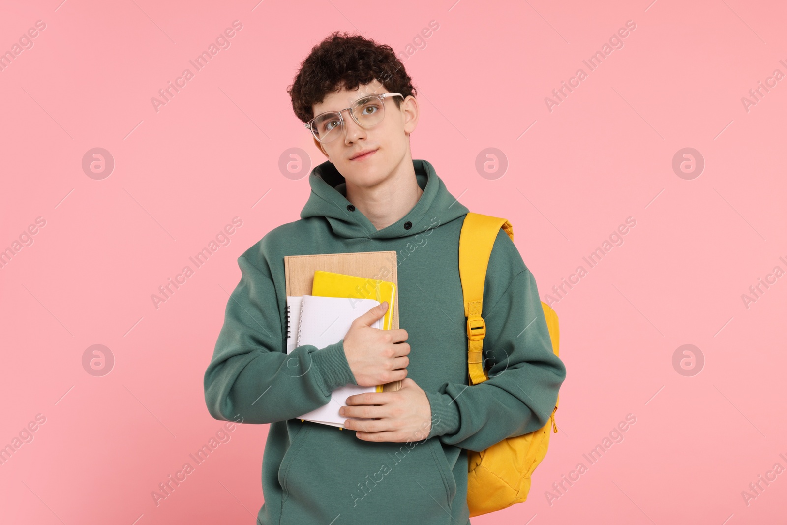 Photo of Portrait of student with backpack and notebooks on pink background