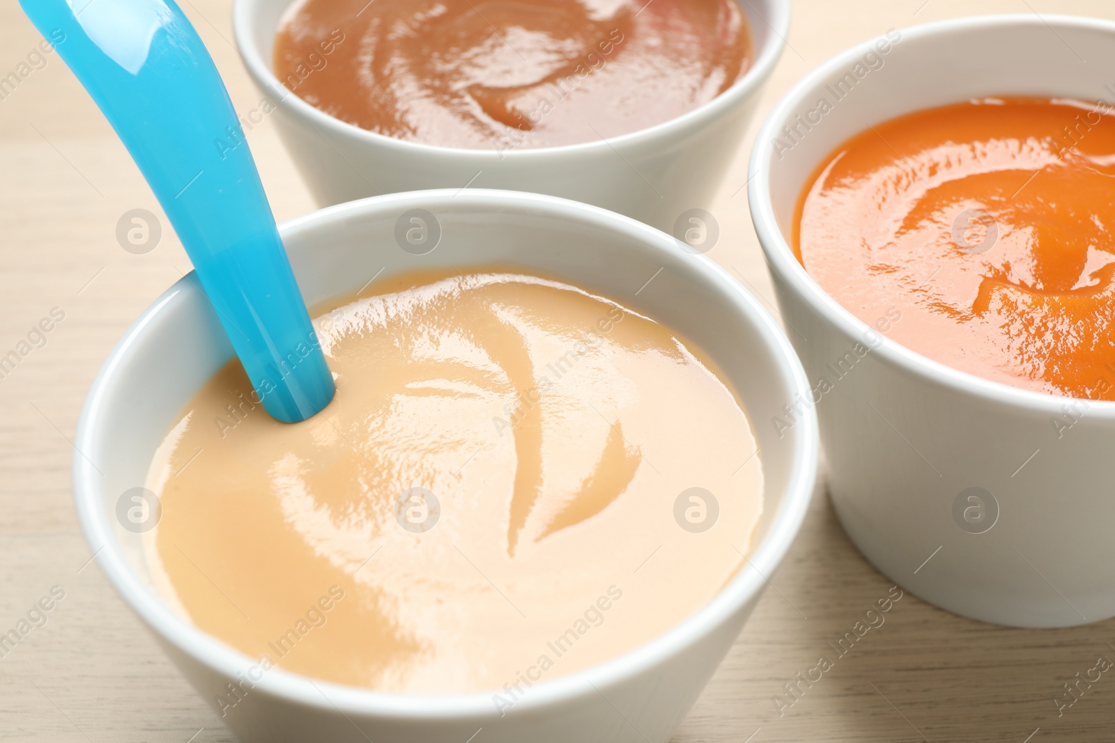 Photo of Healthy baby food on wooden table, closeup