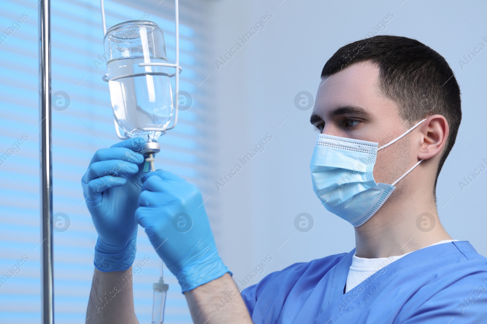 Photo of Nurse setting up IV drip in hospital