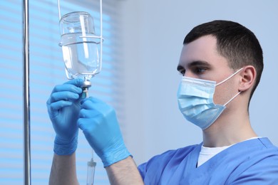 Photo of Nurse setting up IV drip in hospital