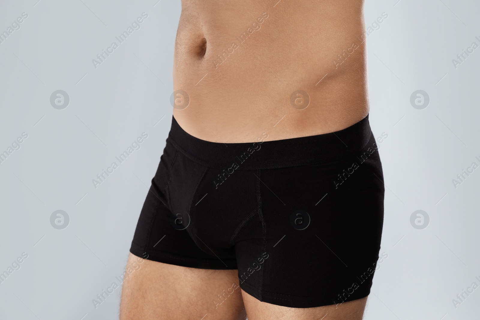 Photo of Man in black underwear on light grey background, closeup