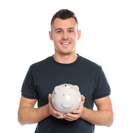Portrait of man with piggy bank on white background