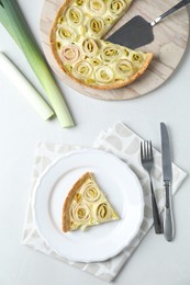 Photo of Tasty leek pie served on white table, flat lay