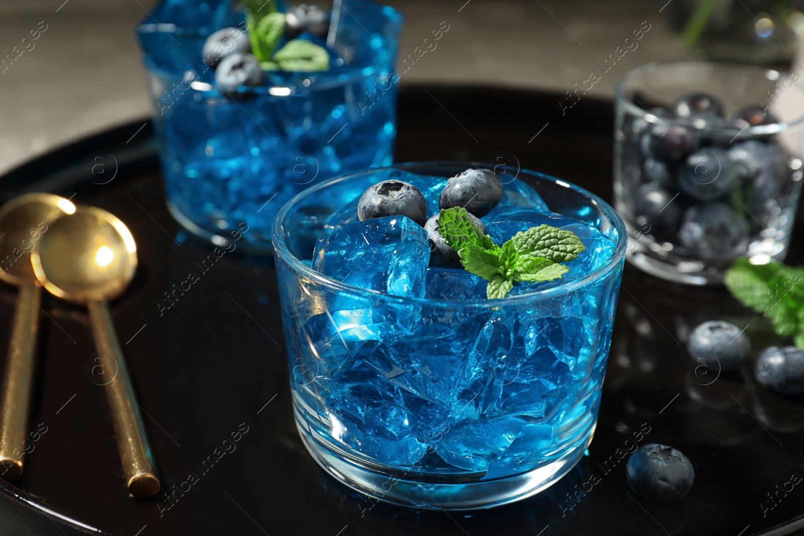 Photo of Glass of berry jelly on tray, closeup