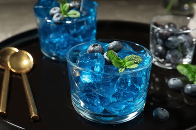 Photo of Glass of berry jelly on tray, closeup