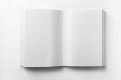 Photo of Mockup of open book on white background, top view