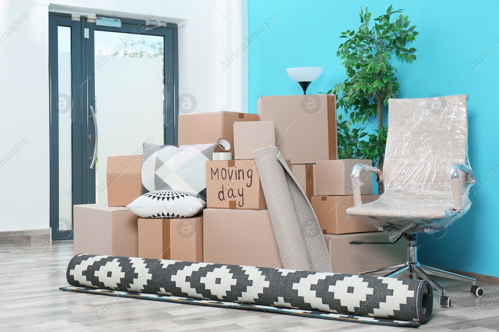 Photo of Cardboard boxes and household stuff in empty room. Moving day