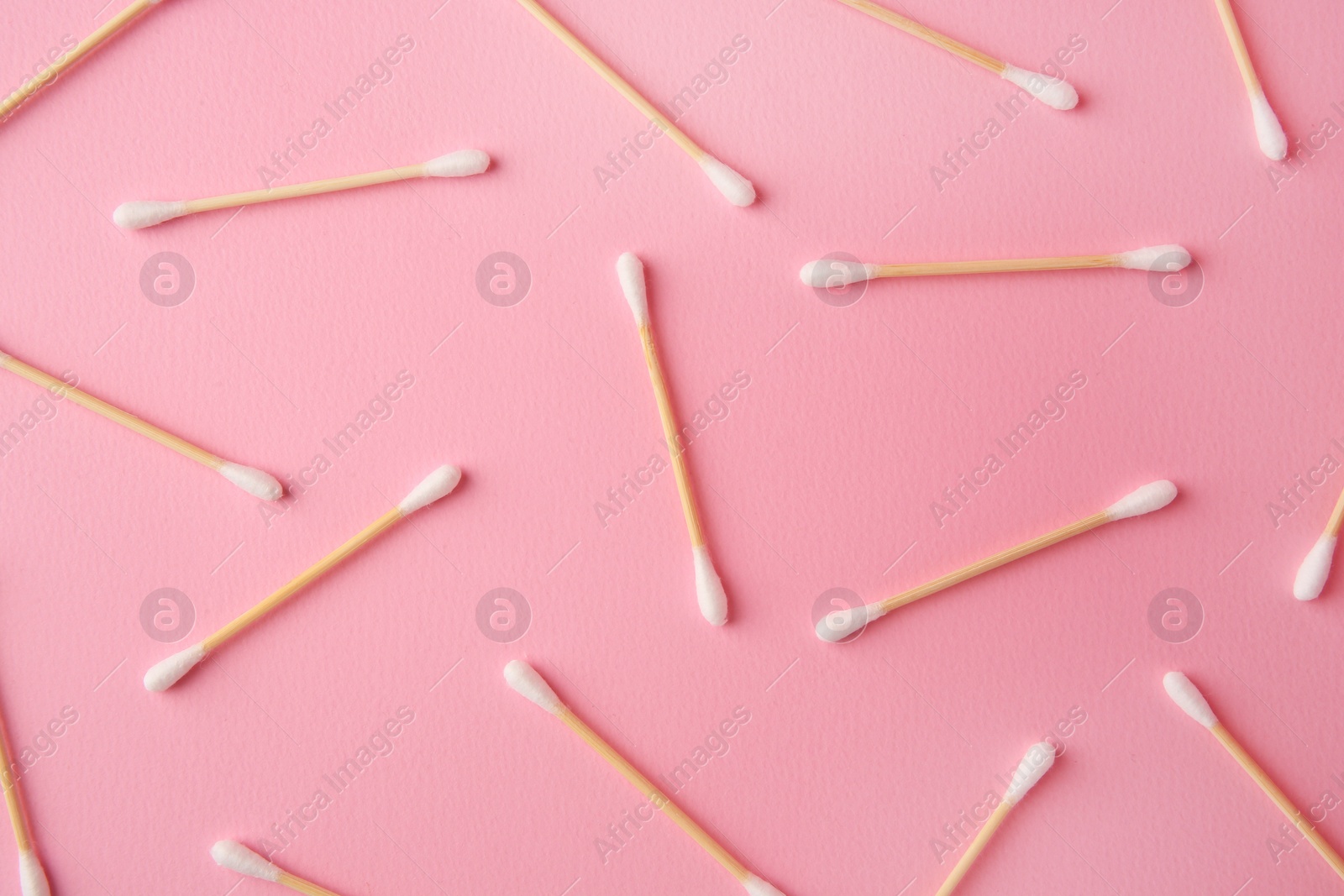 Photo of Many clean cotton buds on pink background, flat lay