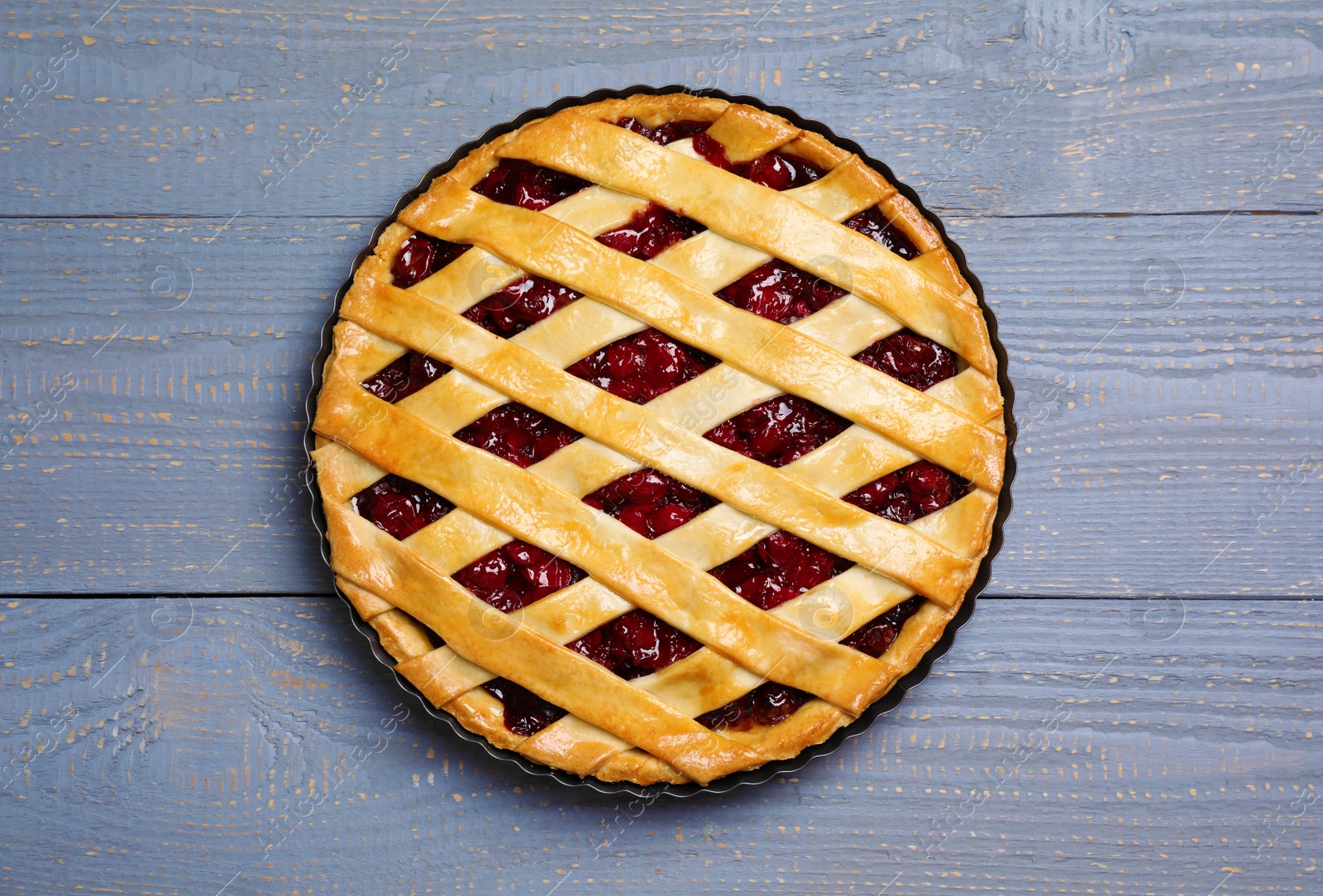 Photo of Delicious fresh cherry pie on light grey wooden table, top view