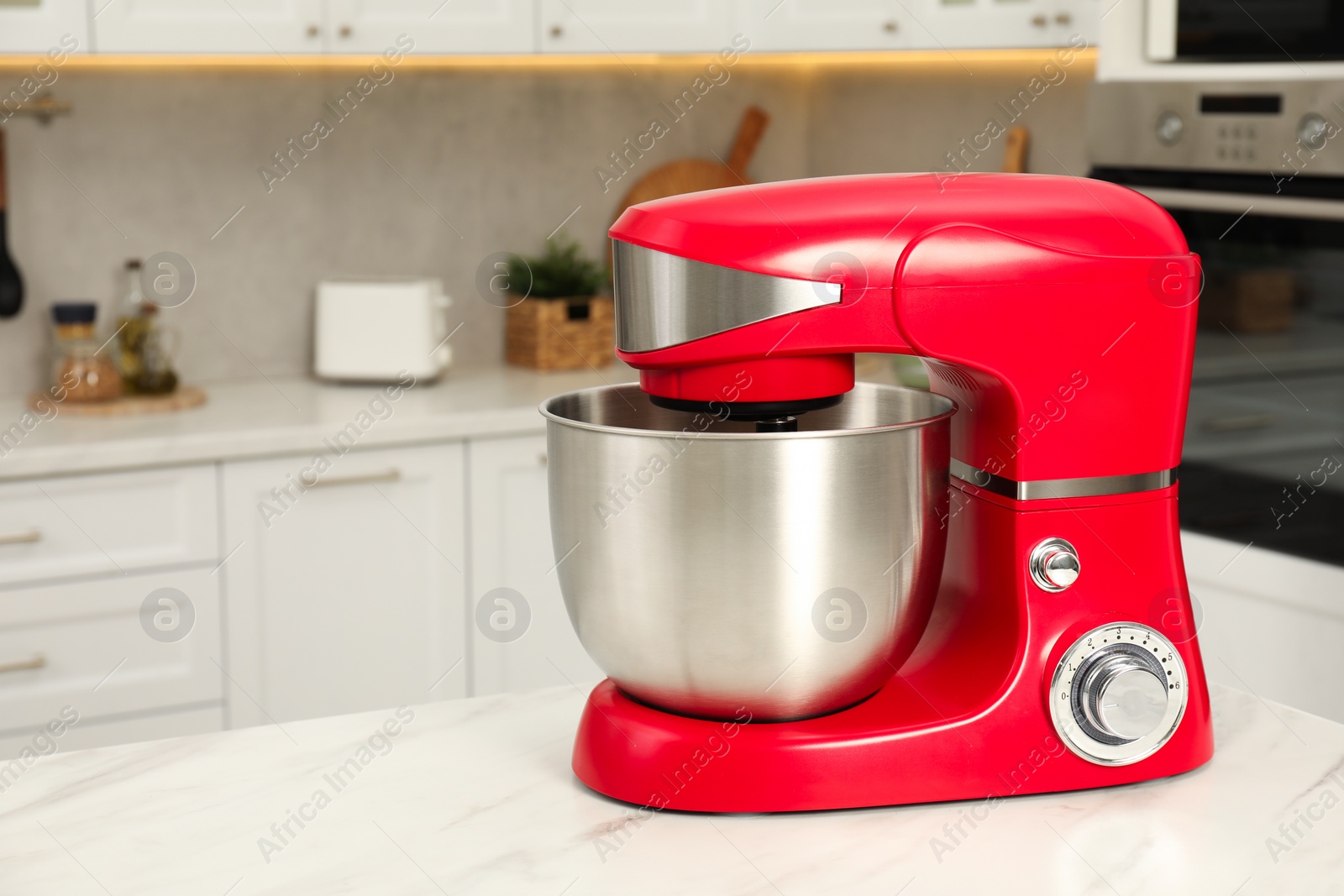 Photo of Modern red stand mixer on white marble table in kitchen, space for text