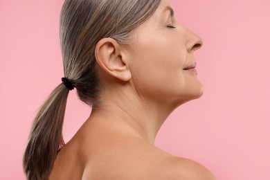 Photo of Beautiful woman with healthy skin on pink background