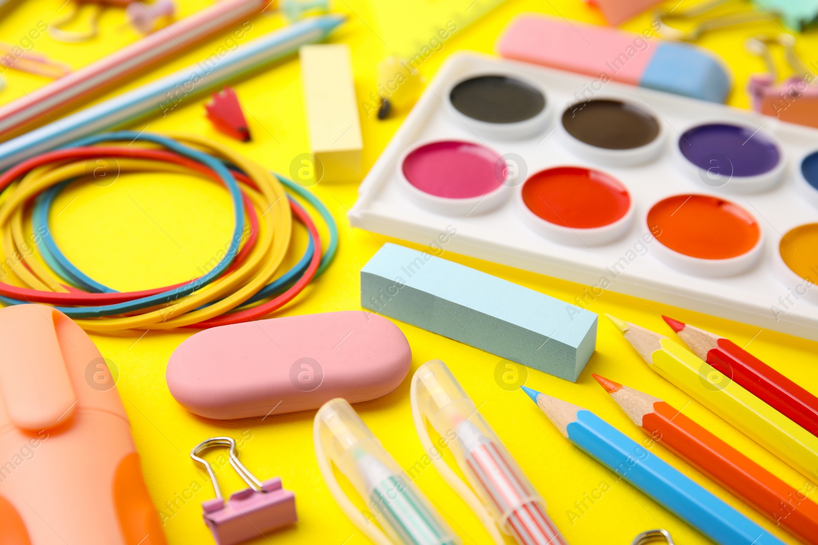 Photo of Different school stationery on yellow background, closeup. Back to school