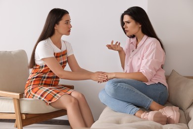Professional psychologist working with young woman in office