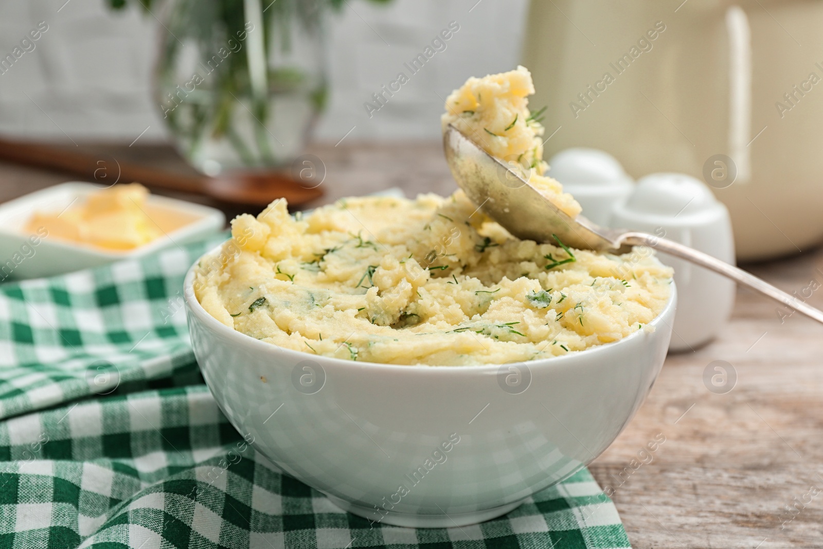 Photo of Bowl with tasty mashed potato on wooden table