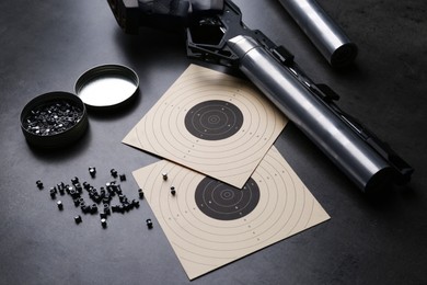 Photo of Composition with sport pistol on black table. Professional gun