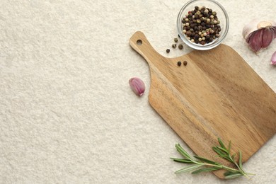 Photo of Cutting board, garlic, pepper and rosemary on white textured table, flat lay. Space for text