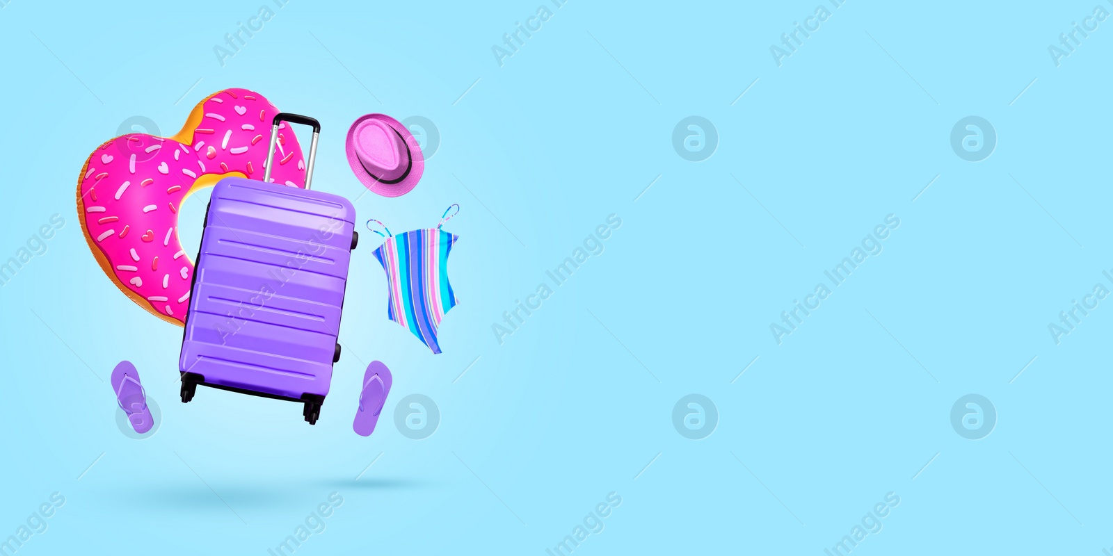 Image of Suitcase and beach accessories flying on light blue background. Banner design with space for text