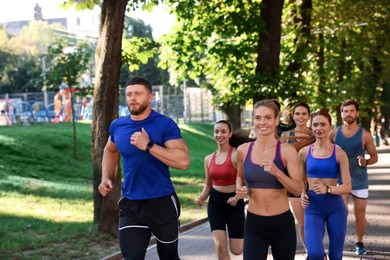 Photo of Group of people running in park. Active lifestyle