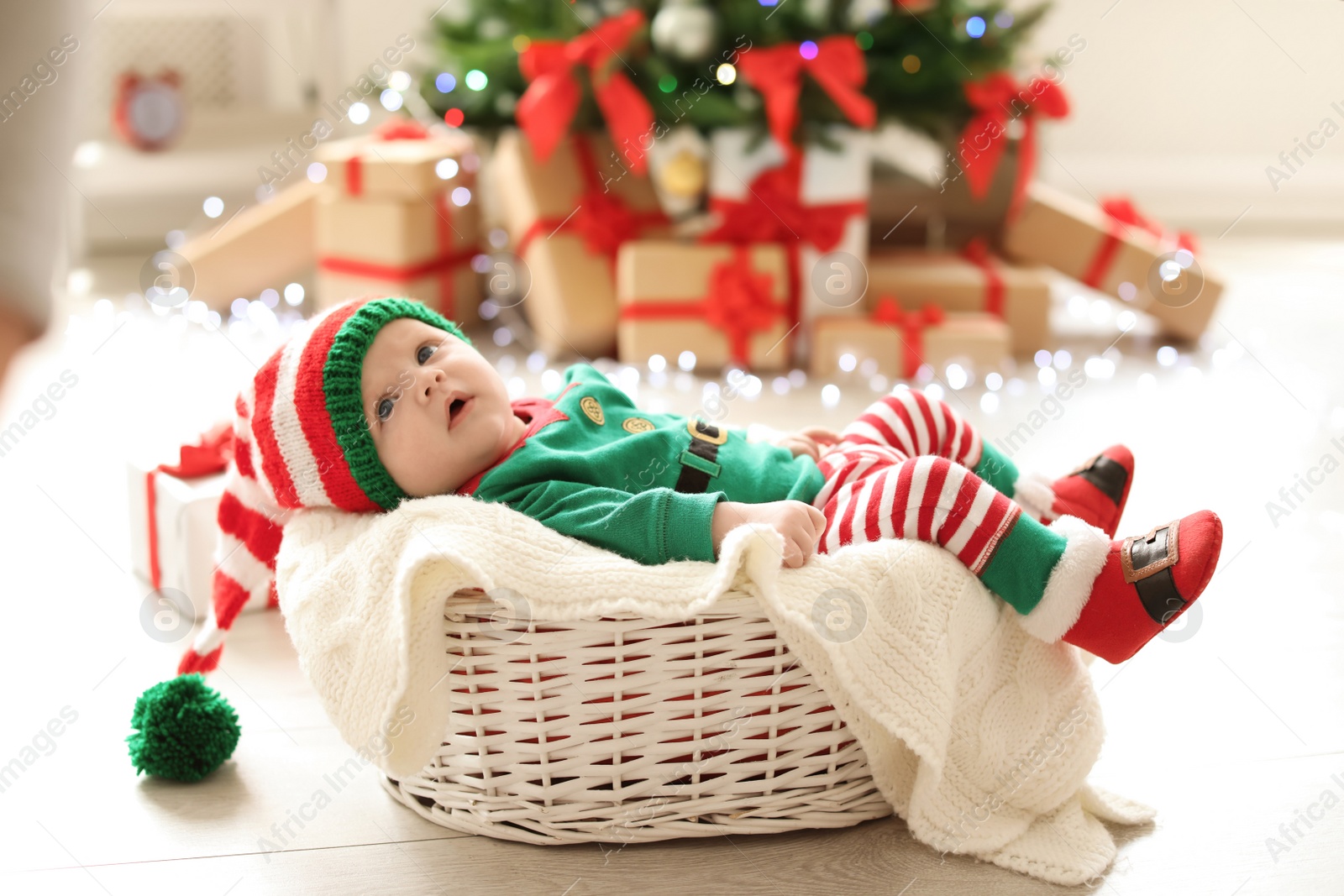 Photo of Cute baby in Christmas costume at home