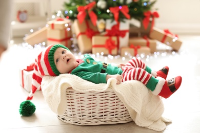 Photo of Cute baby in Christmas costume at home