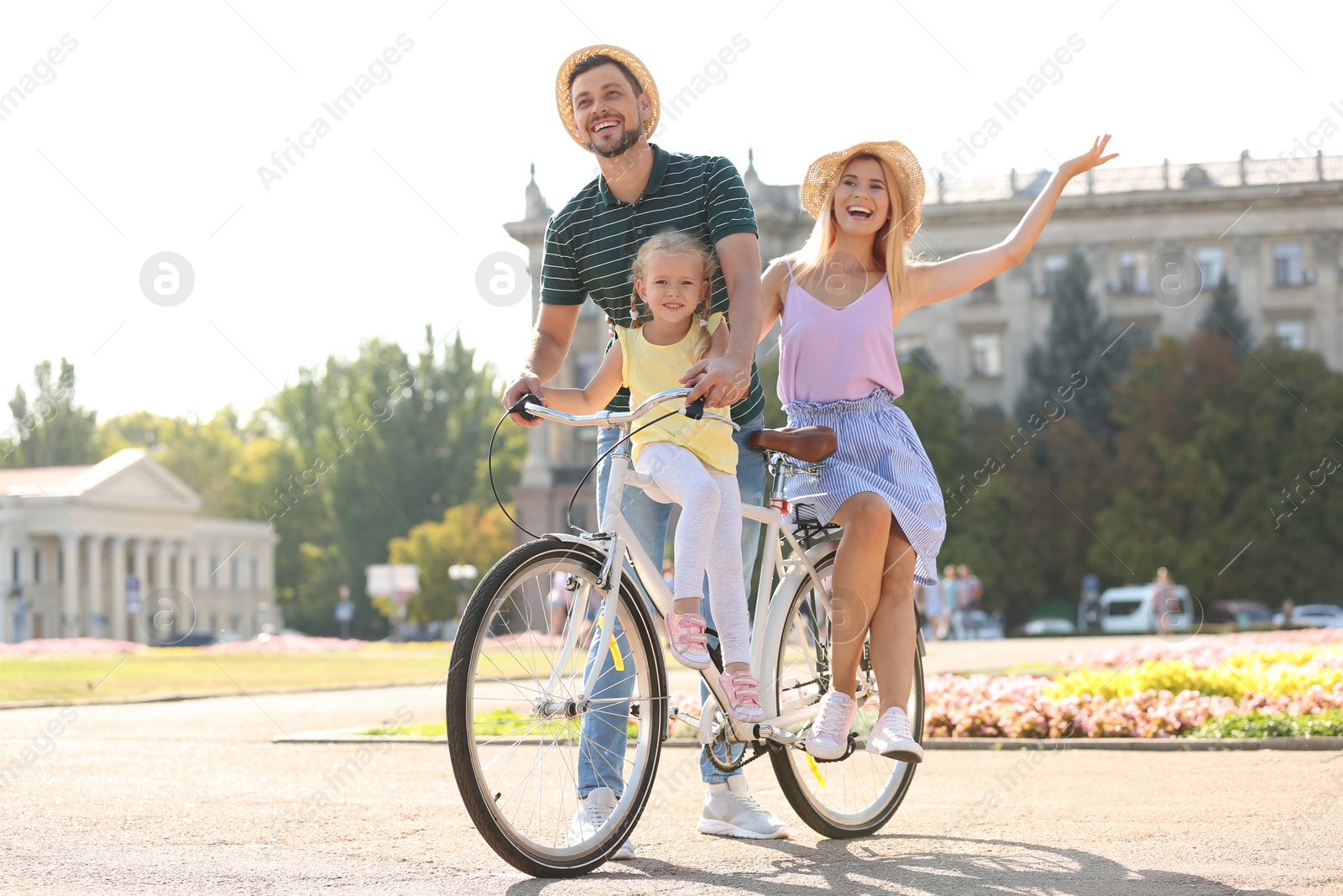 Photo of Happy family with bicycle outdoors on summer day