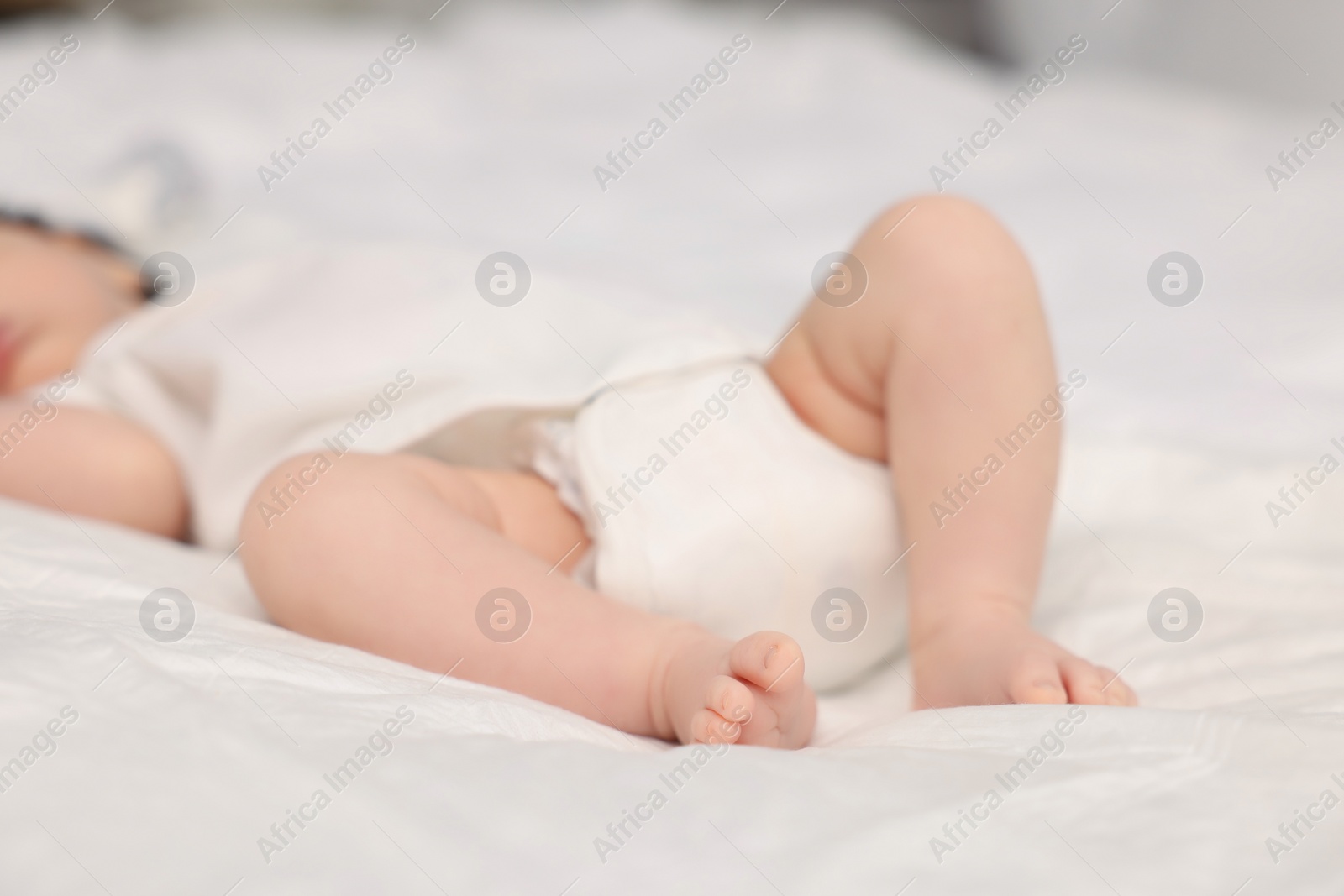 Photo of Cute newborn baby sleeping on bed, closeup