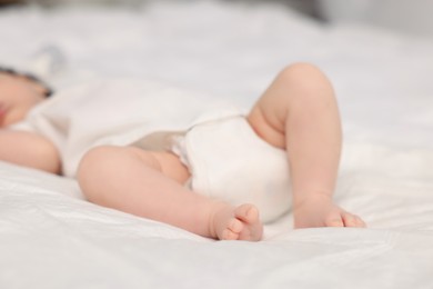 Cute newborn baby sleeping on bed, closeup