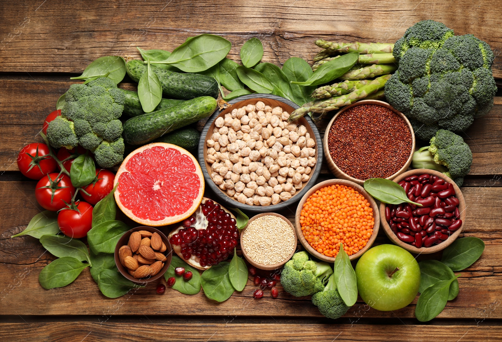 Photo of Fresh vegetables, fruits and seeds on wooden table, flat lay