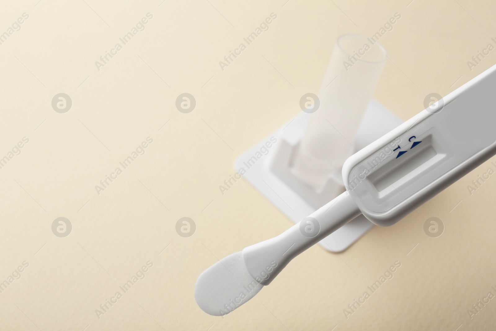 Photo of Disposable express test on beige background, closeup. Space for text