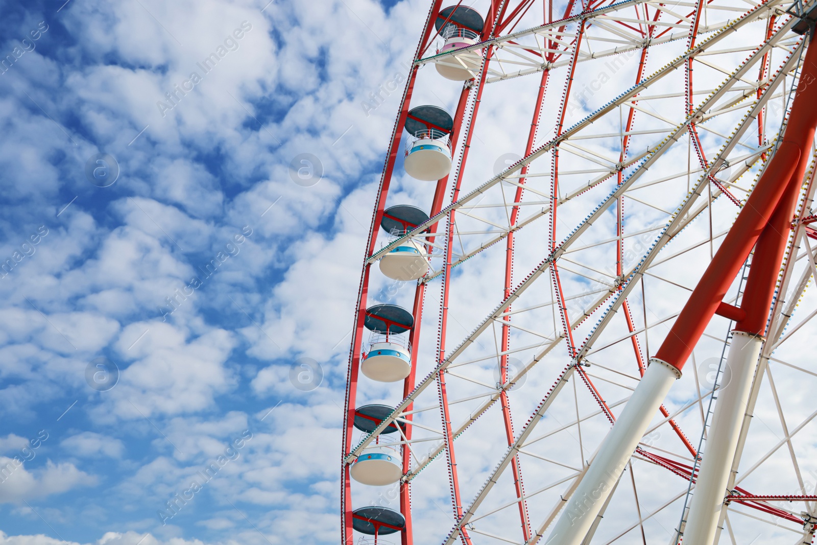 Photo of Beautiful large Ferris wheel outdoors, low angle view. Space for text