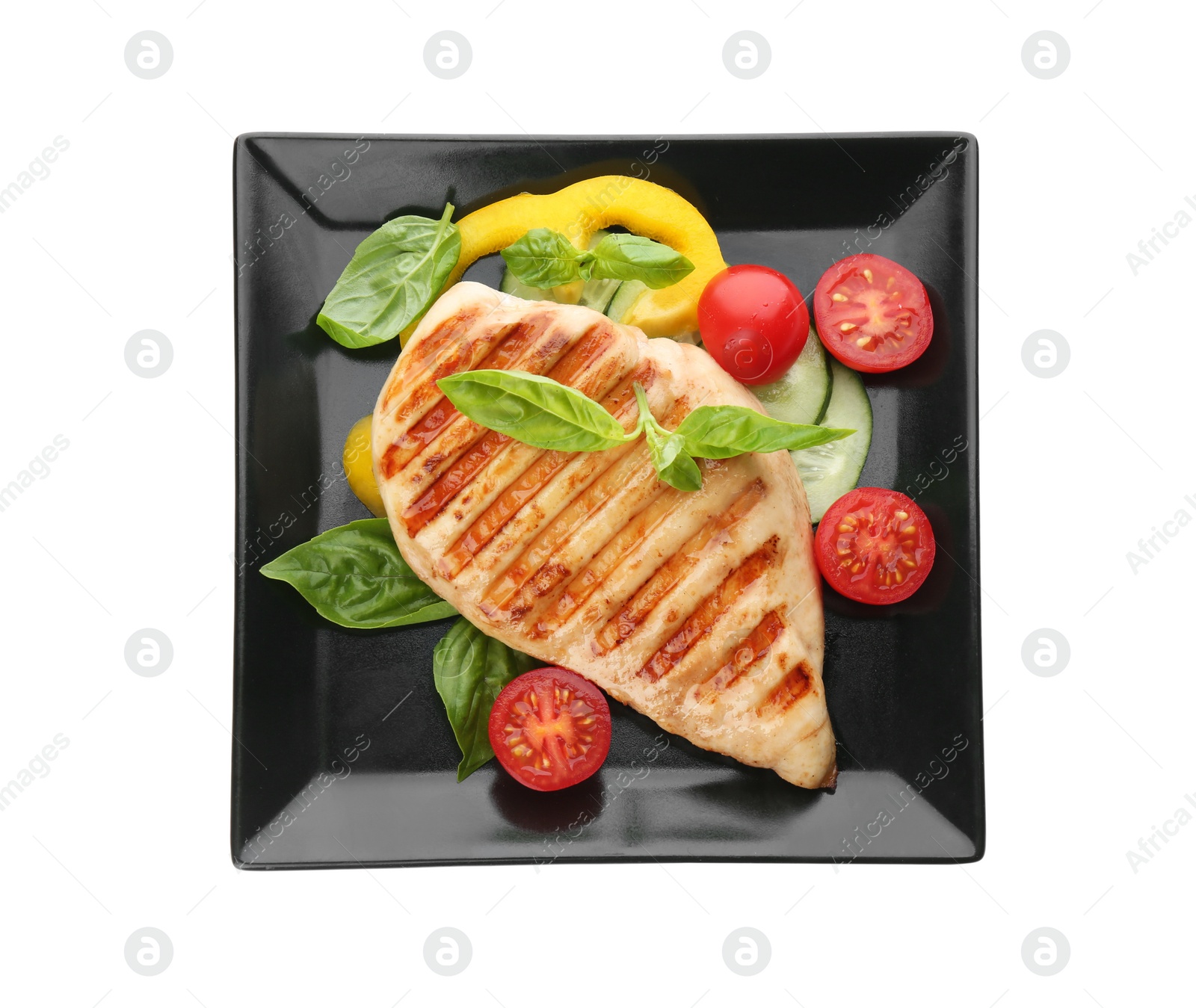Photo of Tasty grilled chicken fillet with green basil and vegetables isolated on white, top view