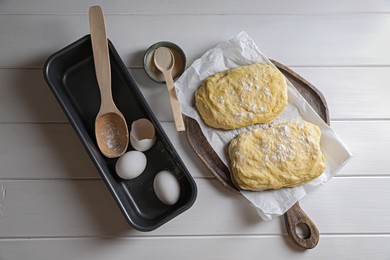 Photo of Dough, eggs and flour on white wooden table, flat lay. Cooking ciabatta