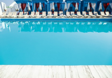Photo of Blurred view of clean swimming pool on sunny day