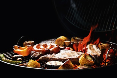 Photo of Assorted delicious meat and vegetables on barbecue grill