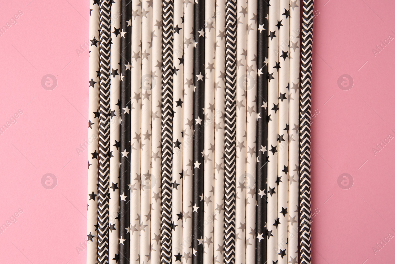 Photo of Many paper drinking straws on pink background, flat lay