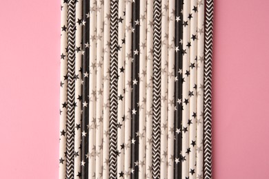 Photo of Many paper drinking straws on pink background, flat lay