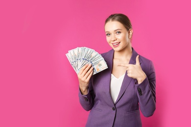 Photo of Portrait of happy young businesswoman with money on color background. Space for text